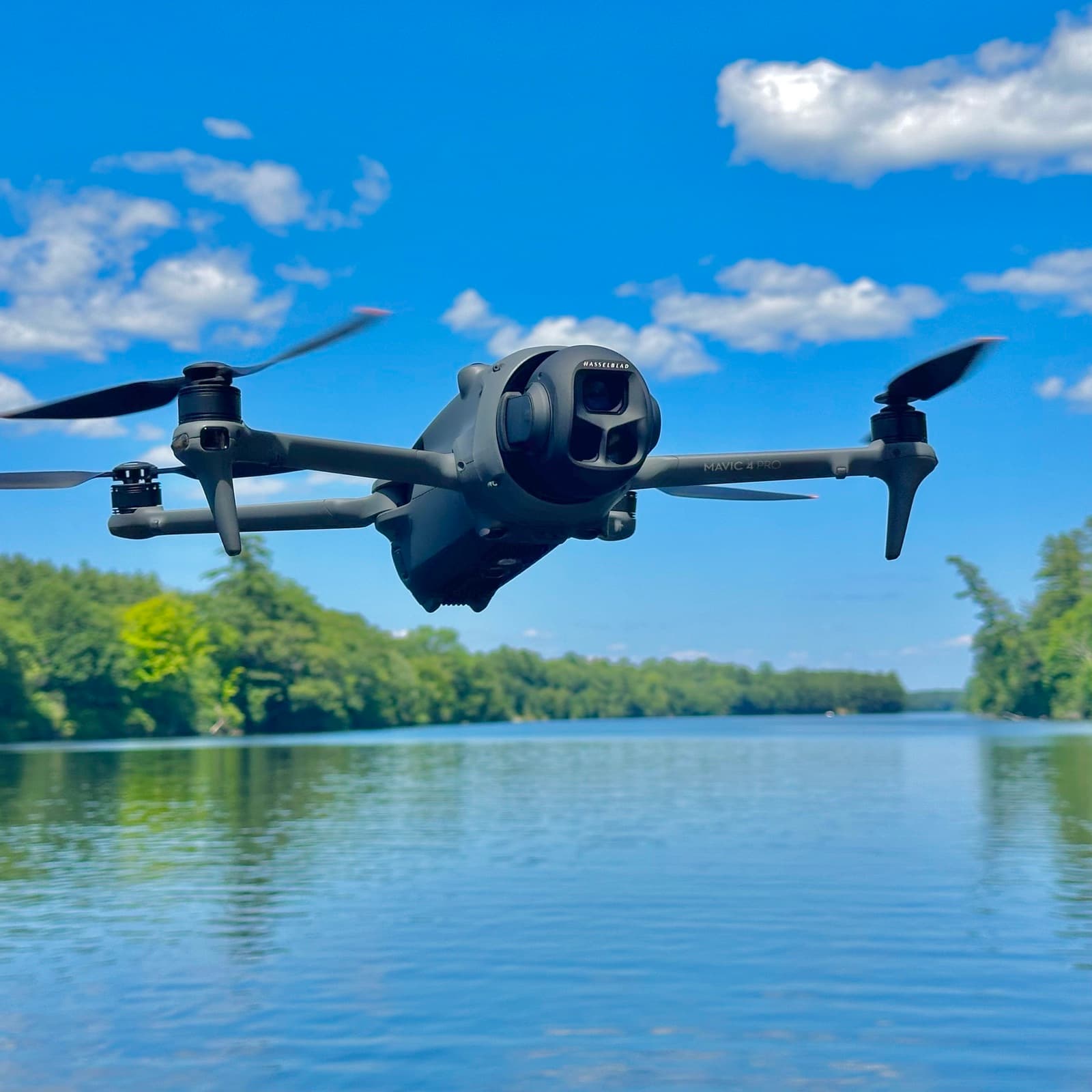 DJI Mavic 4 Pro drone in flight against a blue sky